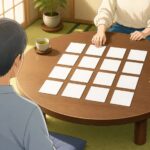 和室のちゃぶ台に無地のカードが16枚並び、2人が向かい合って座っているイラスト